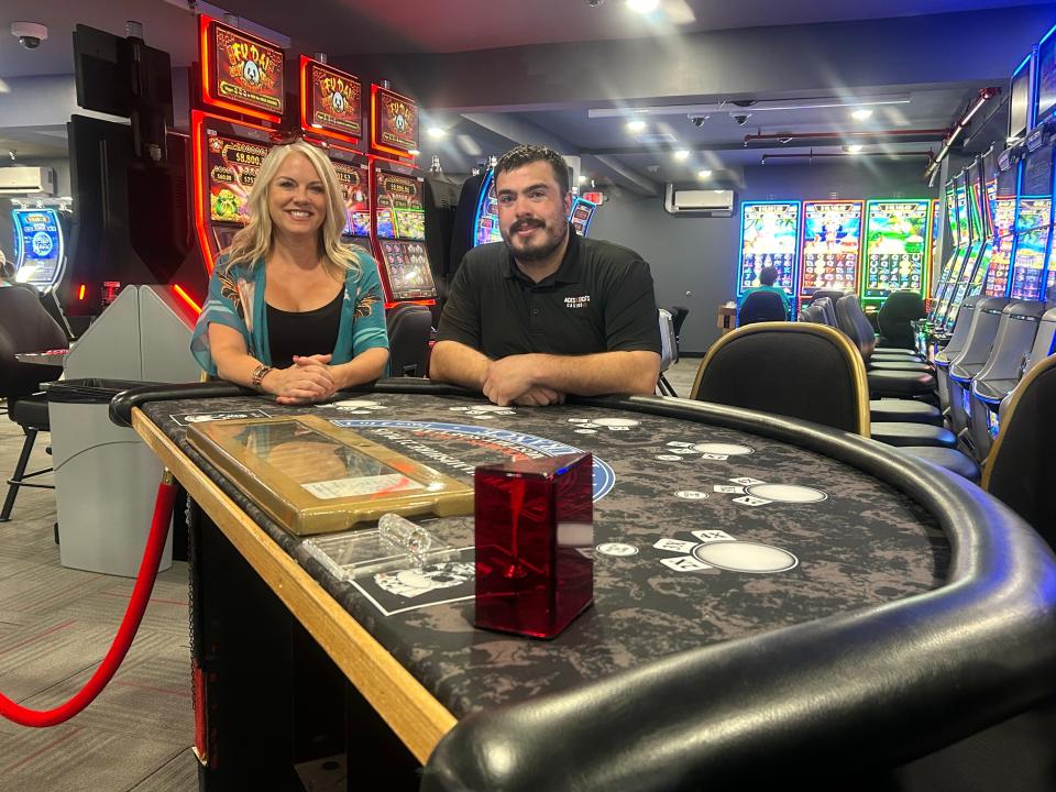 Christie Cartwright, senior director of marketing and communications for Lupoli Companies (the parent company) and Aces and Eights Casino general manager Tim Schmitt pose for a photo in the new 14,000-square-foot expansion of the casino.