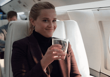 woman smirking on a plane