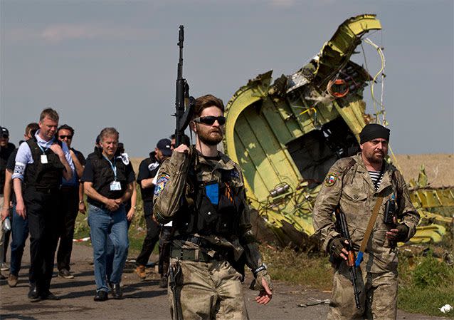 Pro-Russia rebels move journalists away from Malaysian investigators and monitors from the Organisation for Security and Co-operation in Europe on July 22, 2014 in Grabovo. Source: AP Photo