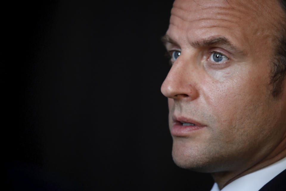 French President Emmanuel Macron talks with social workers and volunteers in charge of assisting the elderly in the area during a visit at a communal center for social action (CCAS) in La Courneuve near Paris, Tuesday April 7, 2020. The new coronavirus causes mild or moderate symptoms for most people, but for some, especially older adults and people with existing health problems, it can cause more severe illness or death. (Gonzalo Fuentes/Pool via AP)