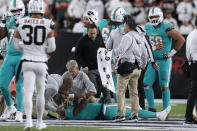 Miami Dolphins quarterback Tua Tagovailoa is examined during the first half of the team's NFL football game against the Cincinnati Bengals, Thursday, Sept. 29, 2022, in Cincinnati. (AP Photo/Jeff Dean)