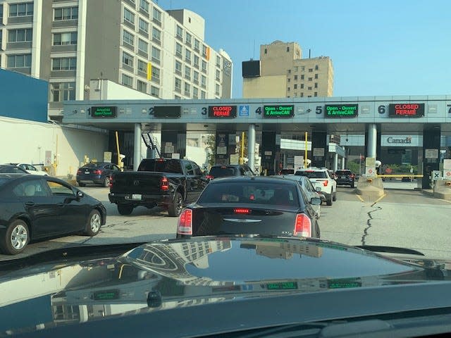 Cars line up to enter Canada from Detroit on Monday, Aug. 9, the first day vaccinated Americans may visit Canada for nonessential travel since the pandemic.