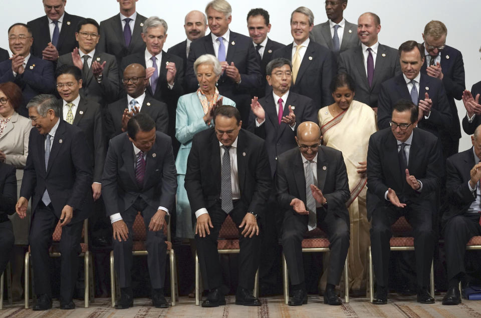 Participants finish their family photo session of the G20 finance ministers and central bank governors meeting Sunday, June 9, 2019, in Fukuoka, western Japan. (AP Photo/Eugene Hoshiko)