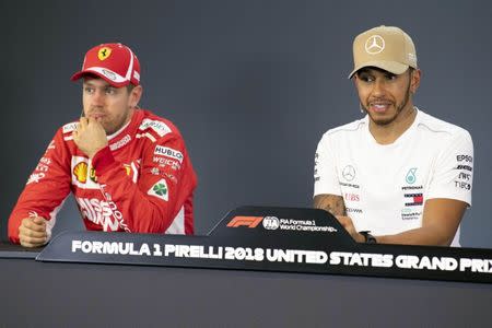 Oct 20, 2018; Austin, TX, USA; Ferrari driver Sebastian Vettel of Germany (left) and Mercedes driver Lewis Hamilton of Great Britain (right) are interviewed after Hamilton takes the pole position during qualifying for the Unites States Grand Prix at Circuit of the Americas. Mandatory Credit: Jerome Miron-USA TODAY Sports