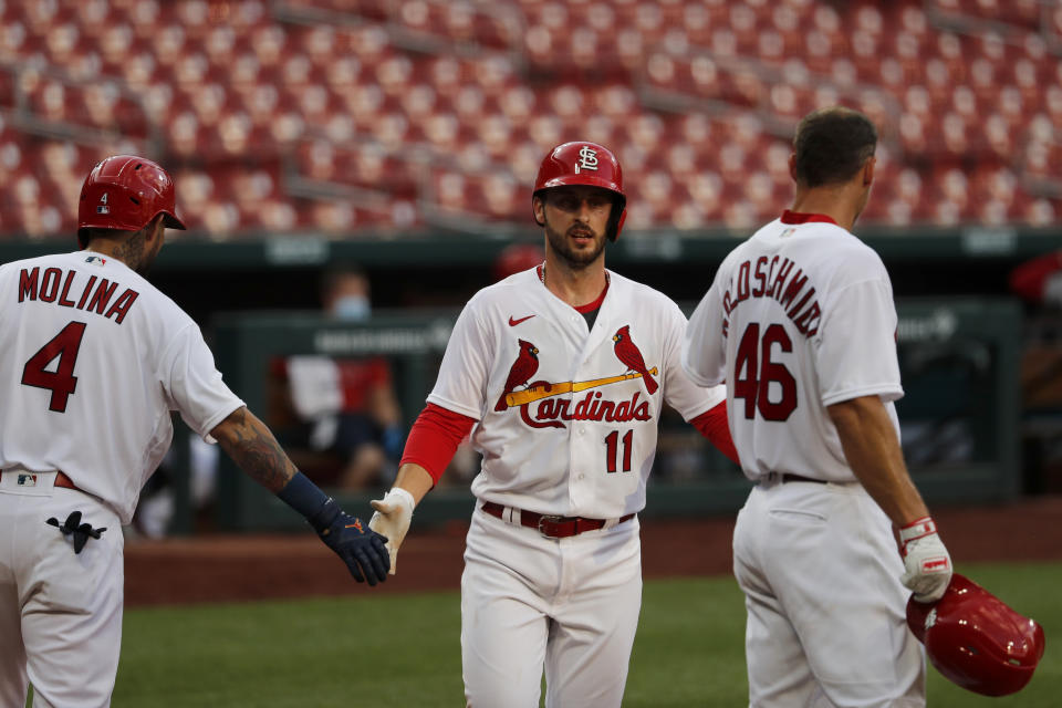 St. Louis Cardinals' Paul DeJong (11) is congratulated by teammates Yadier Molina (4) and Paul Goldschmidt (46) after hitting a two-run home run during an intrasquad practice baseball game at Busch Stadium Thursday, July 9, 2020, in St. Louis. (AP Photo/Jeff Roberson)