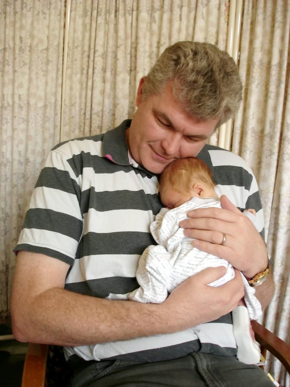 Chris with Adam as a newborn (Irwin Mitchell / SWNS)