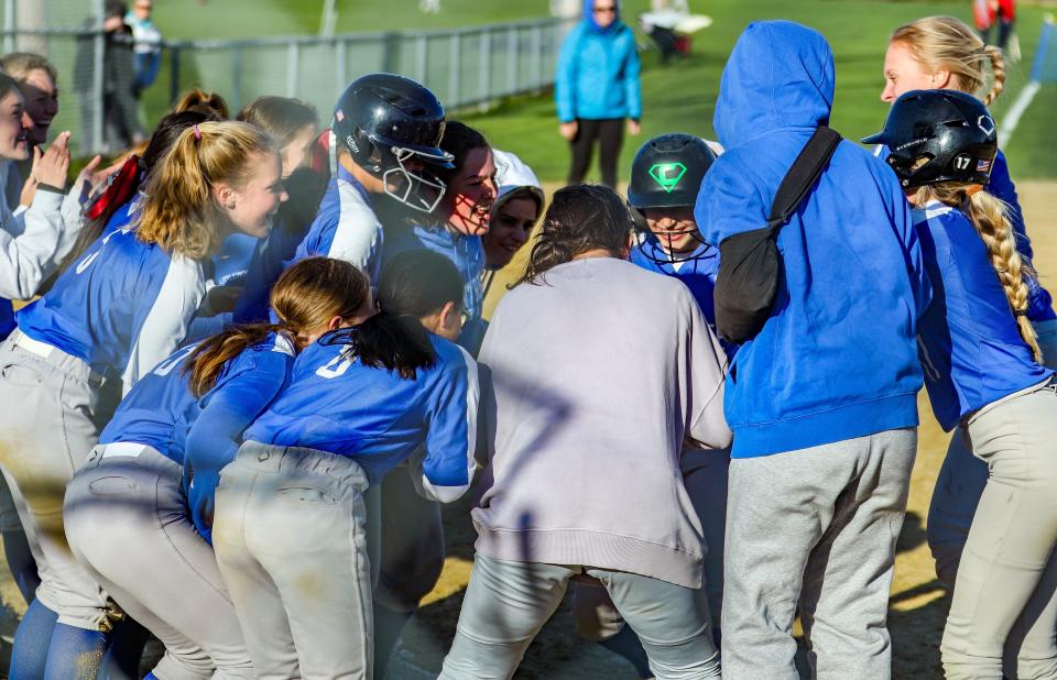 Braintree's Eva Surette is greeted by her teammates as she touches home plate after hitting a home run during a game against Milton on Monday, May 9, 2022.
