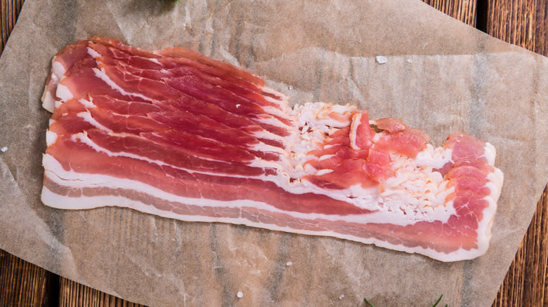 Raw bacon on parchment paper