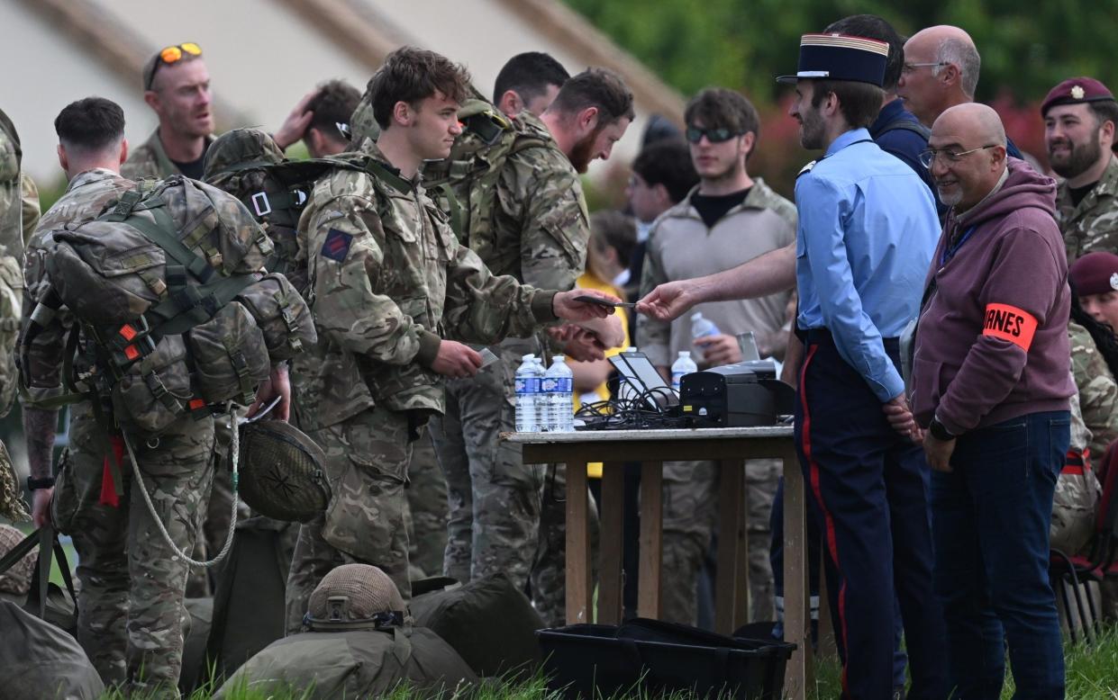 Parachuters have their passports inspected after making the jump