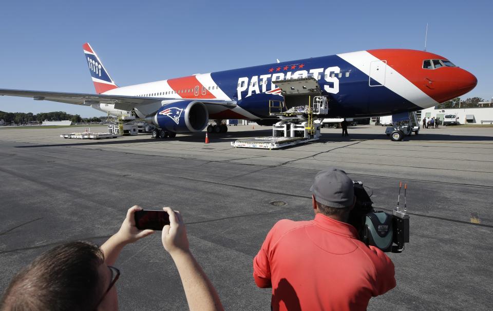 FILE - In this Oct. 4, 2017, file photo, the New England Patriots customized Boeing 767 jet rests on the tarmac at T.F. Green Airport, in Warwick, R.I. The Patriots private team plane is expected to land in Boston on Thursday, April 2, 2020, returning from China with more than one million masks to help control the spread of the coronavirus. The new coronavirus causes mild or moderate symptoms for most people, but for some, especially older adults and people with existing health problems, it can cause more severe illness or death. (AP Photo/Steven Senne, File)