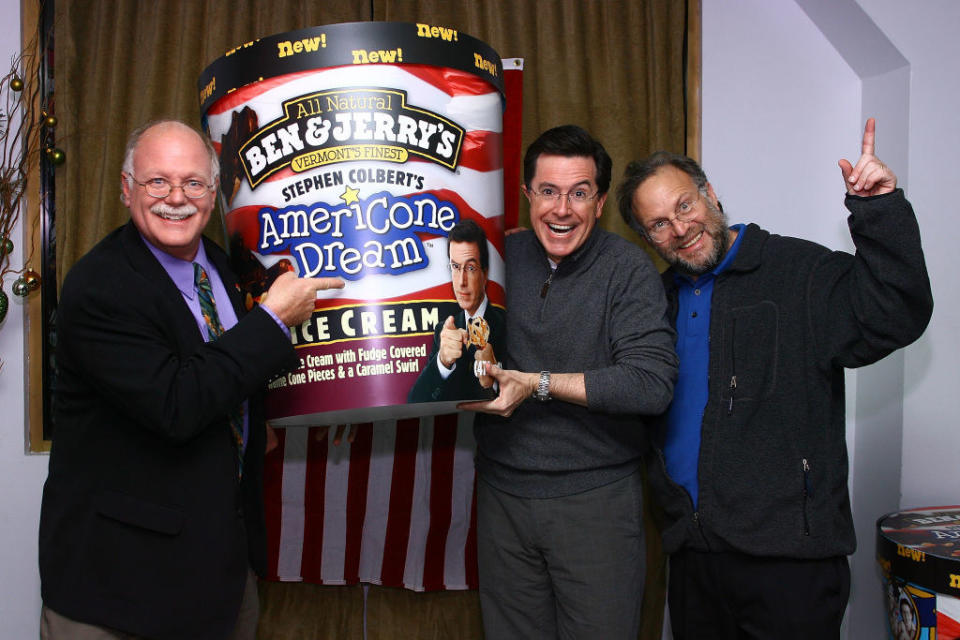 Ben and Jerry pose with Colbert next to a giant fake pint of Americone dream