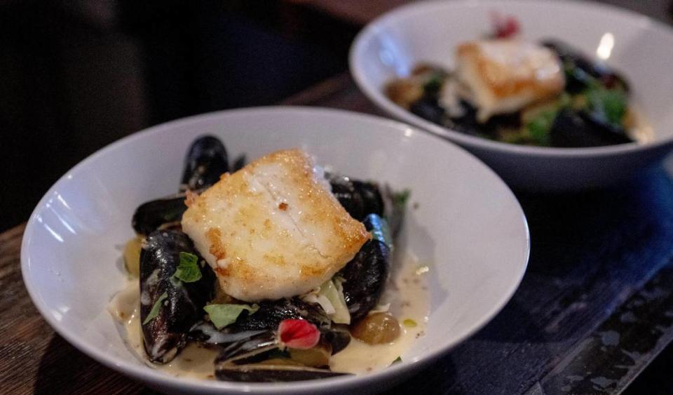 A wild-caught Alaskan halibut dish features mussels, potato, white wine, spring garlic and cream.