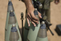 An Israeli soldier from the artillery unit loads a tank shell at the Israeli Gaza border, Saturday, Aug. 6, 2022. Israeli jets pounded militant targets in Gaza as rockets rained on southern Israel, hours after a wave of Israeli airstrikes on the coastal enclave killed at least 11 people, including a senior militant and a 5-year-old girl. The fighting began with Israel's dramatic targeted killing of a senior commander of the Palestinian Islamic Jihad continued into the morning Saturday, drawing the sides closer to an all-out war. (AP Photo/Ariel Schalit)