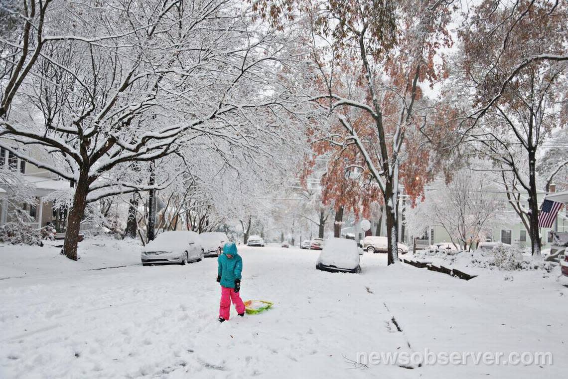 Although much of downtown Raleigh was quiet at daybreak Sunday morning, Dec. 9, 2018, kids in Boylan Heights were already out with their sleds and working on snowmen.