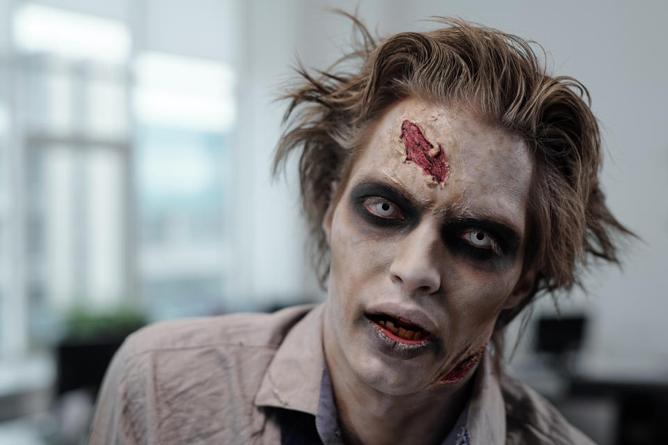 crypto Face of gloomy male zombie with stage makeup
