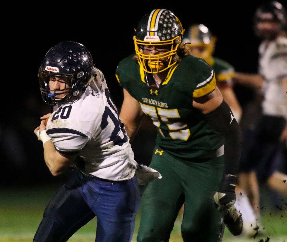 Wilmington Friends' Andrew McKenzie (20) is pursued by the Spartans' Luke Watson in the first quarter of the Quakers' 14-0 DIAA Class 2A state tournament semifinal win at St. Mark's, Saturday, Dec. 3, 2022.