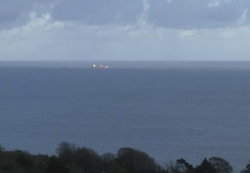 In this image taken from SKY video, shows a tanker at sea, as filmed from land on Sunday Oct. 25, 2020. British police are investigating an undisclosed incident aboard an oil tanker in the English Channel. The incident reportedly took place aboard the Libyan-registered oil tanker Nave Andromeda south of Sandown on Isle of Wight, according to Isle of Wight Radio. (SKY News via AP)