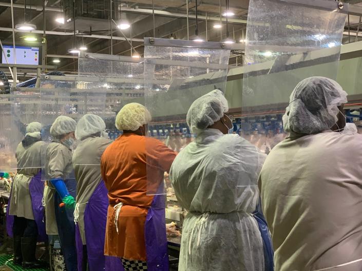 Tyson Foods installed plastic barriers between worker stations at its meat and poultry plants to protect against transmission of the coronavirus.