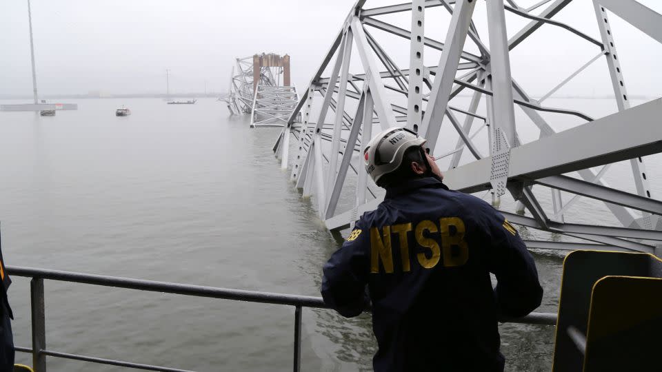 In this NTSB handout, an investigator examines the collapsed Francis Scott Key Bridge from the cargo vessel Dali on March 27 in Baltimore. - Peter Knudson/NTSB/Handout/Getty Images