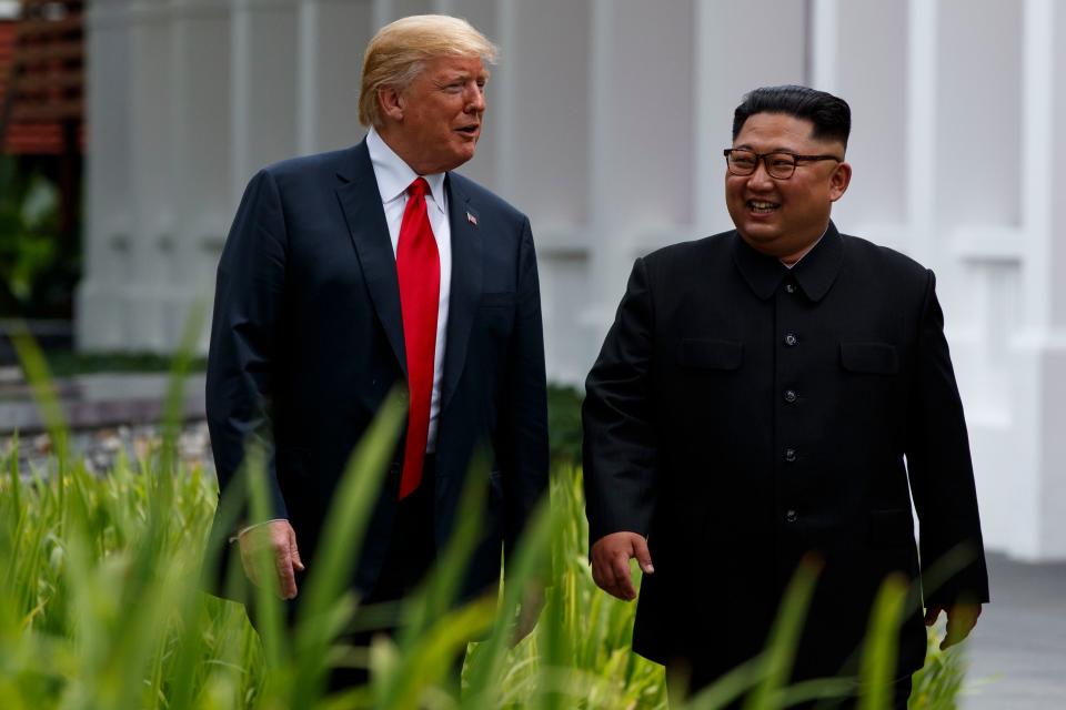 President Donald Trump walks with North Korean leader Kim Jong Un in Singapore on June 12.