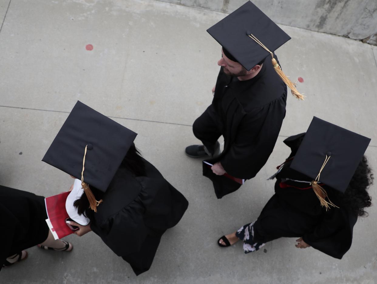 Graduates file into the stands at Ohio Stadium during Spring Commencement on Sunday, May 5, 2019 at Ohio State University in Columbus, Ohio. The university awarded 12,213 degrees and certificates, marking the university's largest graduating class ever. [Joshua A. Bickel/Dispatch]