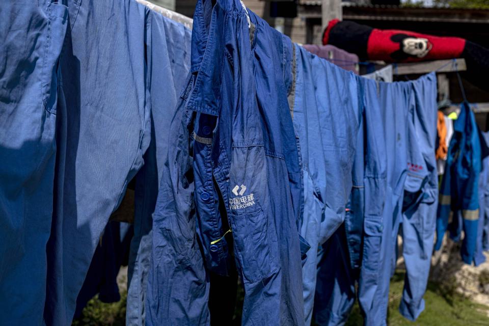 Outfits used at the construction site hang to dry outside the dormitory for workers of the the Kalimantan Industrial Park Indonesia (KIPI) in Kampung Baru, Bulungan regency, North Kalimantan, Indonesia on Thursday, Aug. 24, 2023. The industrial park being built in Indonesia on the tropical island of Borneo that has attracted billions of dollars in foreign and domestic investment is damaging the environment in an area where endangered species live and migrate. (AP Photo/Yusuf Wahil)