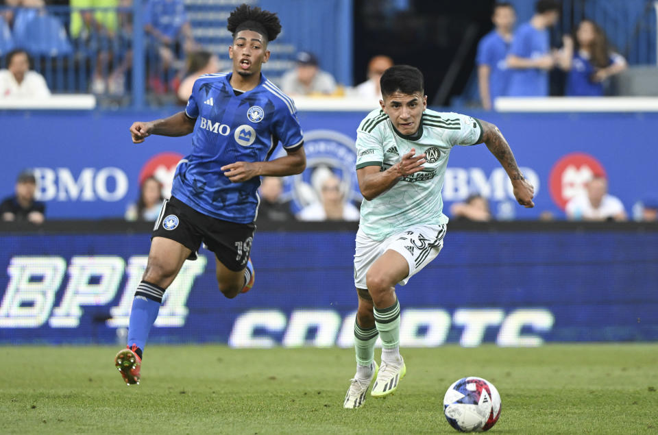 Atlanta United's Thiago Almada (23) breaks away from CF Montreal's Nathan-Dylan Saliba (19) during the first half of an MLS soccer match Saturday, July 8, 2023, in Montreal. (Graham Hughes/The Canadian Press via AP)