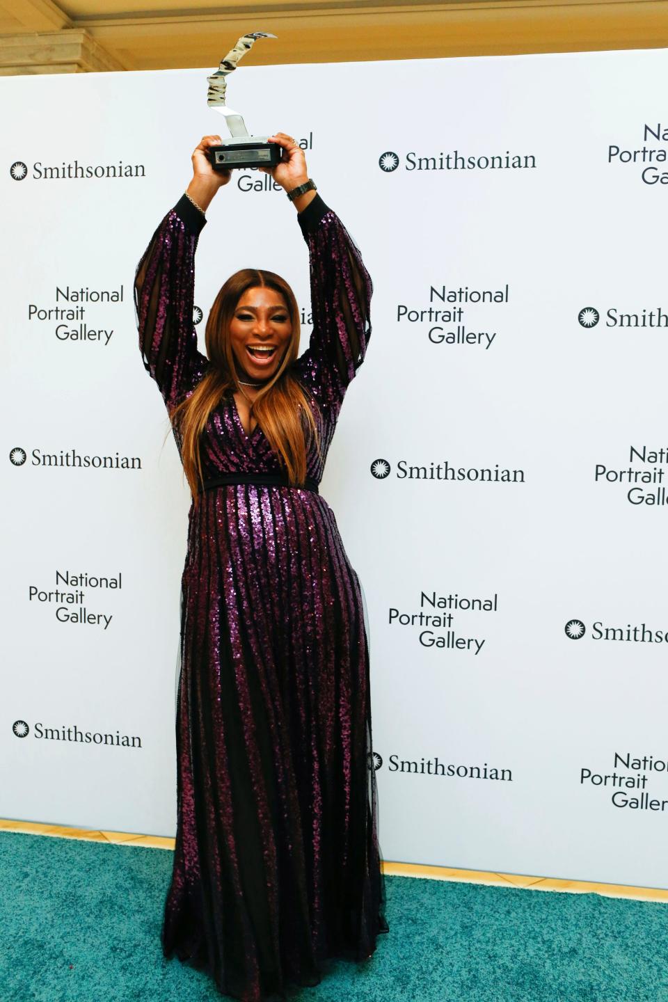 Serena Williams poses with her award at the National Portrait Gallery gala.