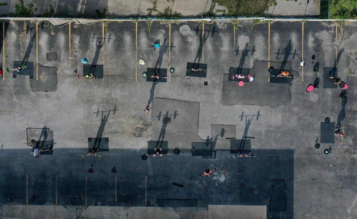 An aerial view of Fitness Instructor Dennis Guerrero leading an outdoor Jetty Gym "Outside The Box" fitness workout on July 20, 2020, in Oceanside, New York. New York Governor Andrew Cuomo announced that gyms will not be permitted to reopen during phase 4 until New York's Health Department determines if air filtering systems are circulating the coronavirus. More than 3,900,000 people in the United States alone have been infected with the coronavirus and at least 143,000 have died.