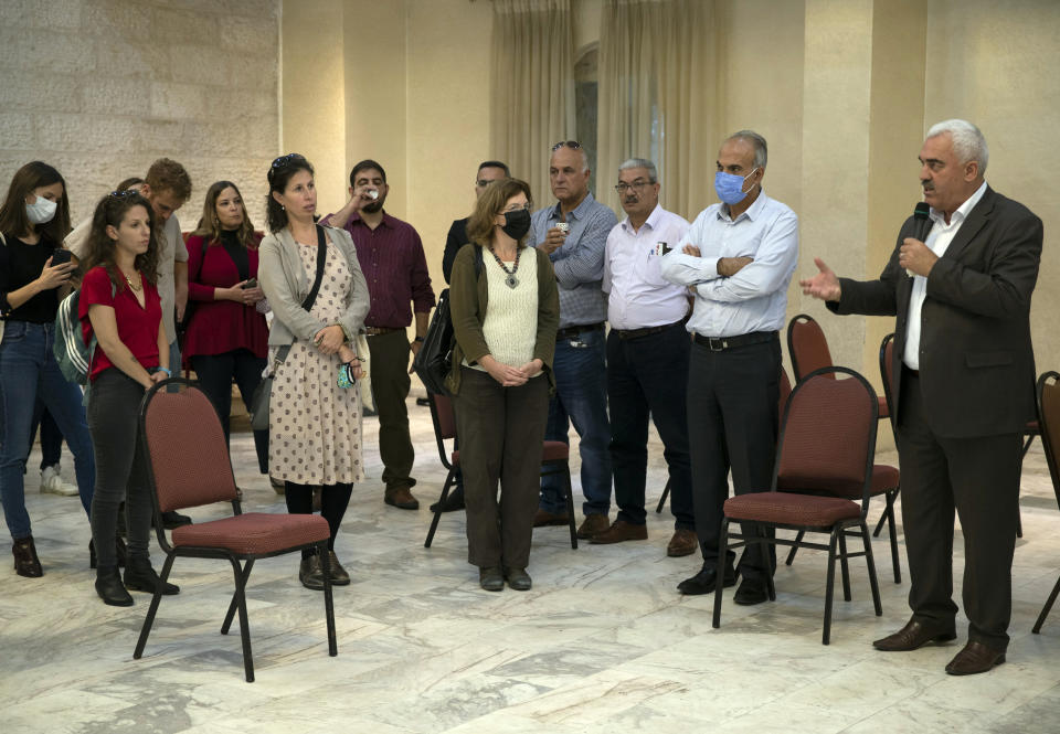 FILE - Shawan Jabarin, right, director of the al-Haq human rights group, speaks during a rare meeting of solidarity between leaders from Israeli human rights organizations and representatives from six Palestinian human rights groups outlawed by Israel, in the West Bank city of Ramallah, Oct. 27, 2021. The cellphones of six Palestinian human rights activists were infected with spyware from the notorious Israeli hacker-for-hire company NSO Group as early as July 2020, a security researcher discovered just days before Israel’s defense minister branded some of their employers terrorist organizations, including al-Haq. It was the first time the military-grade Pegasus spyware was known to have been used against Palestinian civil society activists. (AP Photo/Majdi Mohammed, File)