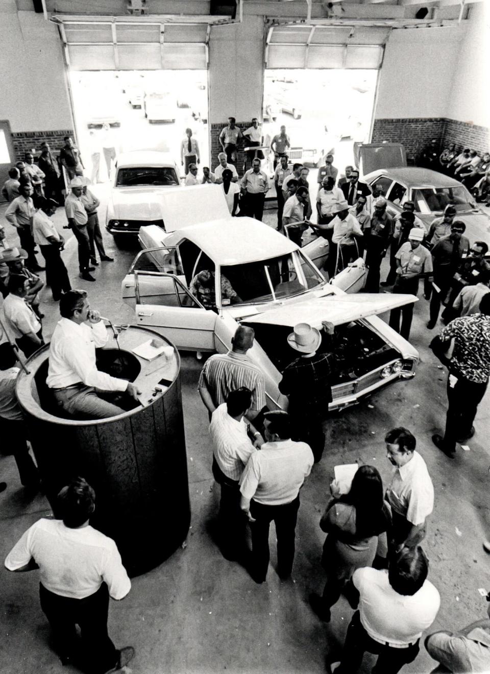 Lubbock Auto Auction Day inspecting cars for auction, date unknown.