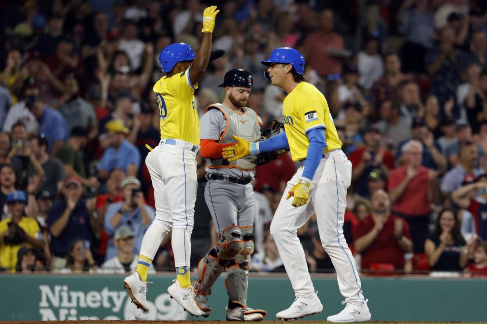 Boston Red Sox's Triston Casas, right, celebrates his three-run home run that scored Pablo Reyes, left, in front of Detroit Tigers catcher Jake Rogers during the fourth inning of a baseball game Friday, Aug. 11, 2023, in Boston. (AP Photo/Michael Dwyer)