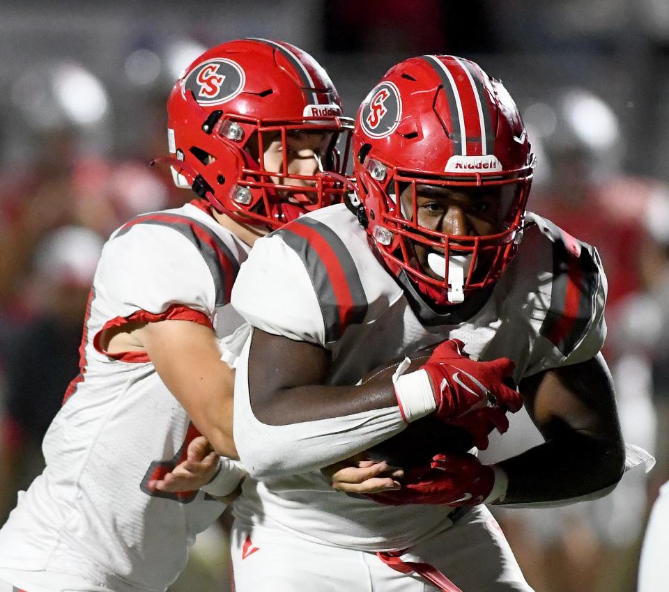 Canton South quarterback Poochie Snyder hands off the wall to Rome Cox to set up a touchdown in the 3rd quarter at Sandy Valley.  Friday, Sept. 01, 2023.