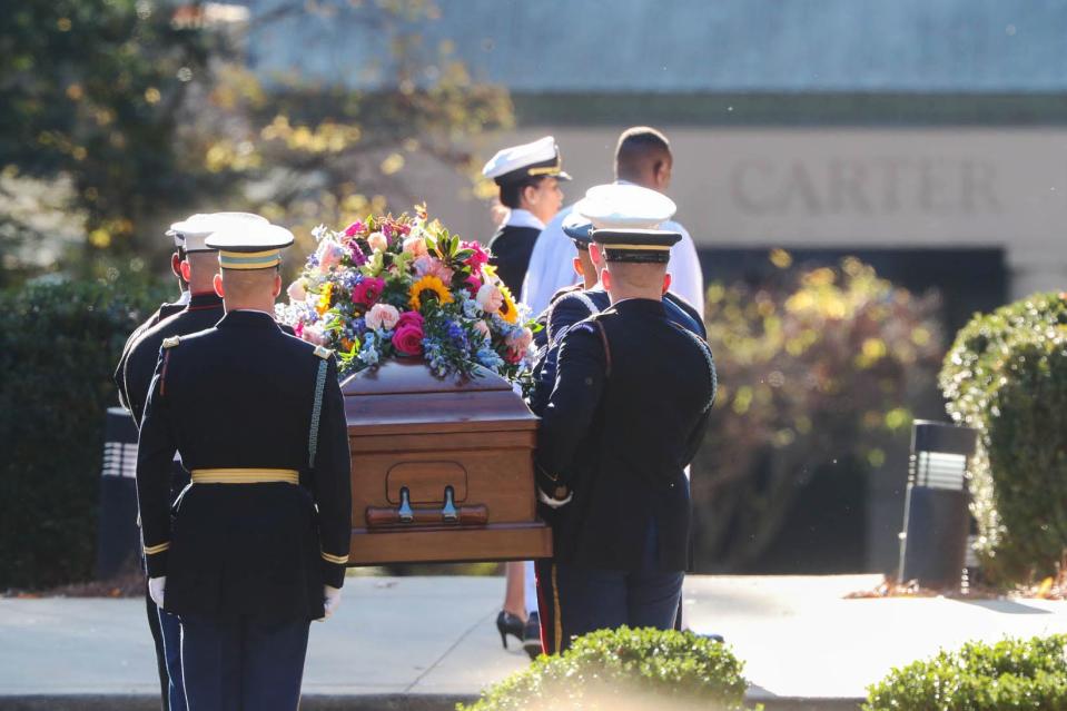 Members of the Armed Forces Body Bearer Team carry the casket of former first lady Rosalynn Carter into the Carter Presidential Center on Monday in Atlanta.