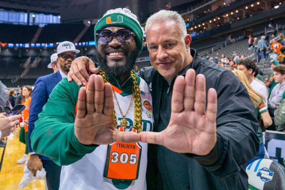 Miami Hurricanes superfan ‘JD Da Boss’ and LifeWallet CEO John Ruiz throw up the U after Miami’s 88-81 Elite Eight win over the University of Texas in the T-Mobile Center in Kansas City, Missouri, on March 26, 2023.