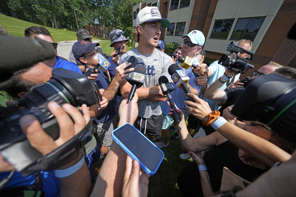 Pittsburgh Steelers quarterback Kenny Pickett, center, is surrounded by media after arriving for the NFL football team's training camp in Latrobe, Pa., Wednesday, July 26, 2023. (AP Photo/Gene J. Puskar)