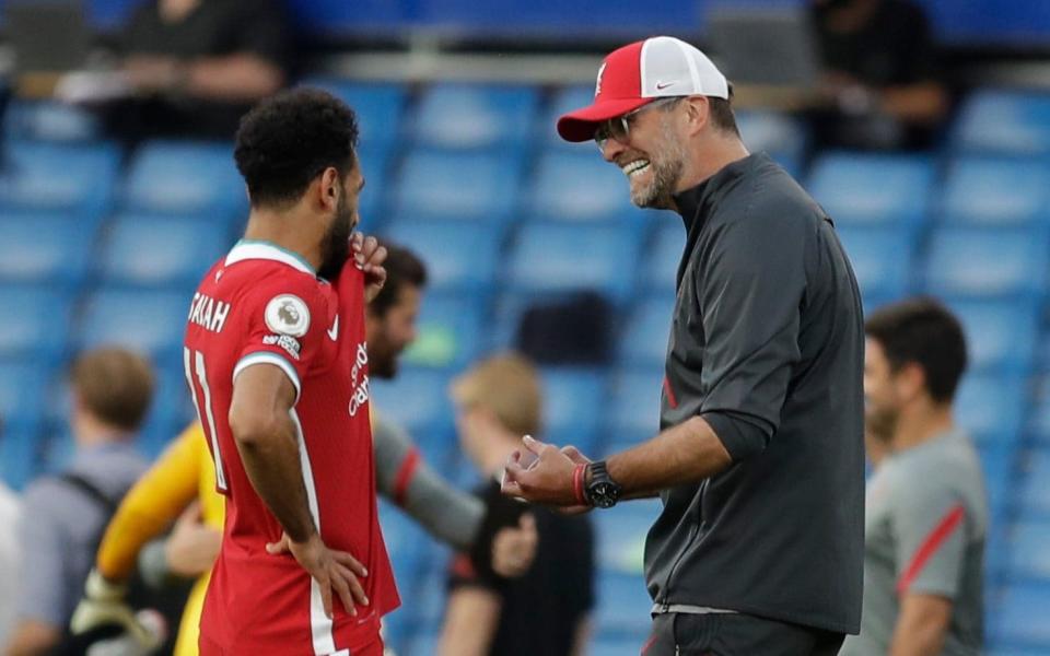 Liverpool's German manager Jurgen Klopp (R) greets Liverpool's Egyptian midfielder Mohamed Salah after winning the English Premier League football match between Chelsea and Liverpool at Stamford Bridge in London on September 20, 2020. - AFP