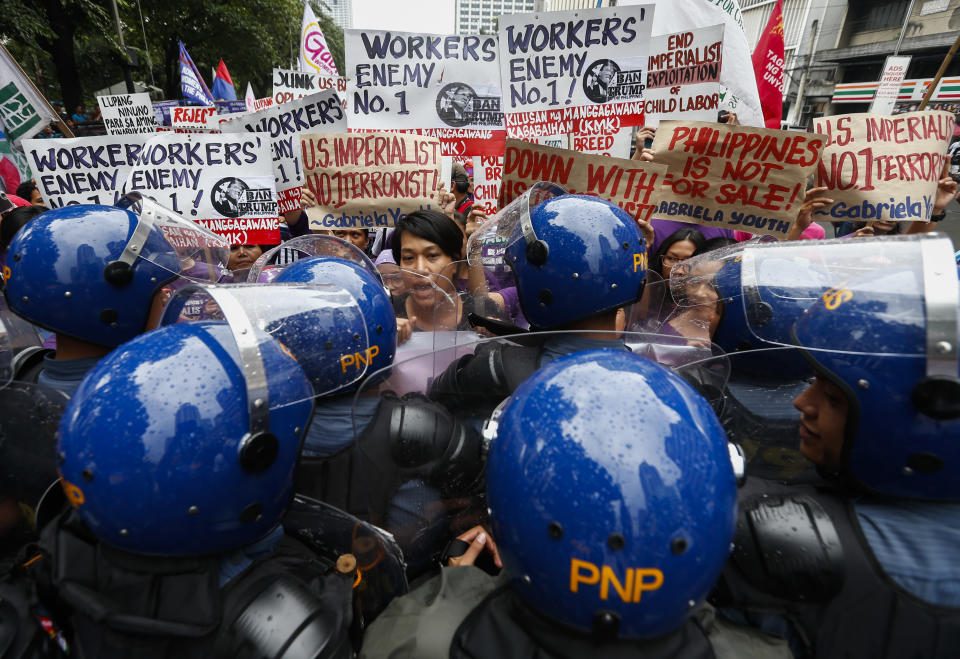 <p>Philippine police block women activists during a demonstration against President Donald J. Trump on a road leading to the U.S. Embassy in Manila, Philippines, Nov. 9, 2017. Women’s rights group Gabriela held a demonstration protesting against the visit of President Trump to the Philippines in time for the 31st Association of South East Asian Nations (ASEAN) Summit in Manila. Protesters called on Philippine President Rodrigo Duterte to resist US influence in Philippine foreign policy.(Photo: Rolex Dela Pena/EPA-EFE/REX/Shutterstock) </p>