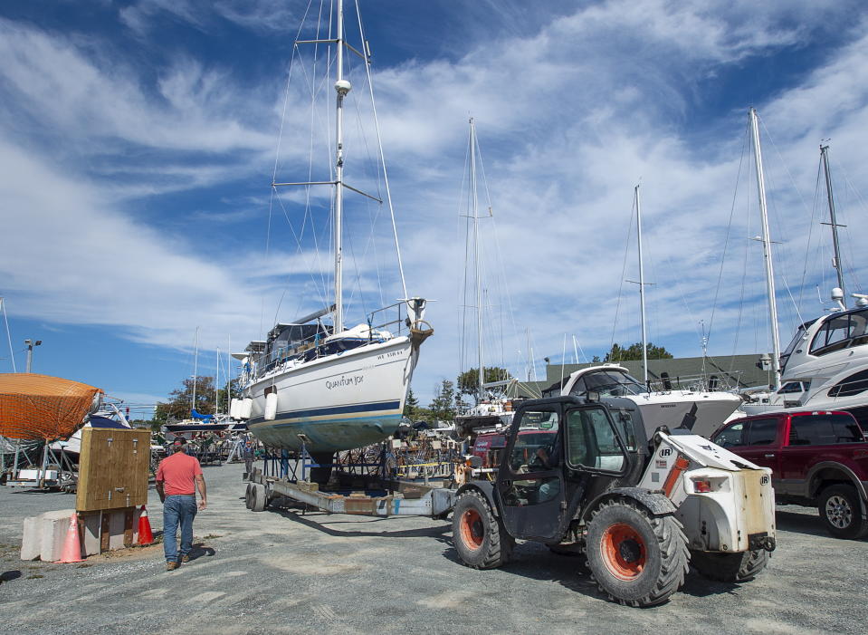 A sailboat is moved into the yard after being pulled from the water at the Dartmouth Yacht Club in Dartmouth, N.S., on Monday, Sept. 21, 2020. Hurricane Teddy is expected to impact the Atlantic region starting mid-day Tuesday as a post-tropical storm, bringing rain, wind and high waves. (Andrew Vaughan/The Canadian Press via AP)