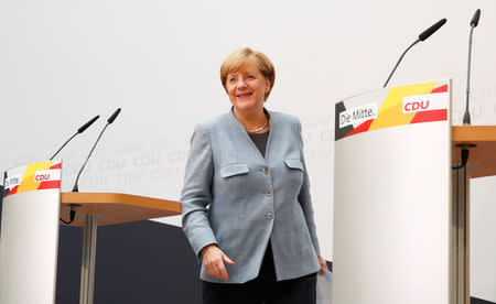 Christian Democratic Union CDU party leader and German Chancellor Angela Merkel is seen leaving after a news conference at the CDU party headquarters, a day after the general election (Bundestagswahl) in Berlin, Germany September 25, 2017. REUTERS/Axel Schmidt/Files