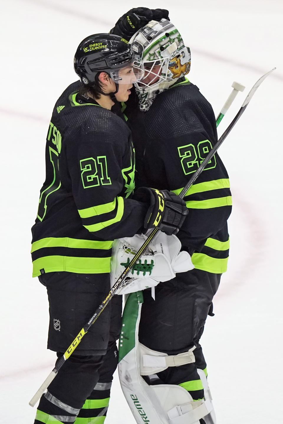 Dallas Stars goaltender Jake Oettinger (29) and left wing Jason Robertson (21) congratulate each other after the team's NHL hockey game against the St. Louis Blues in Dallas, Thursday, April 13, 2023. (AP Photo/LM Otero)