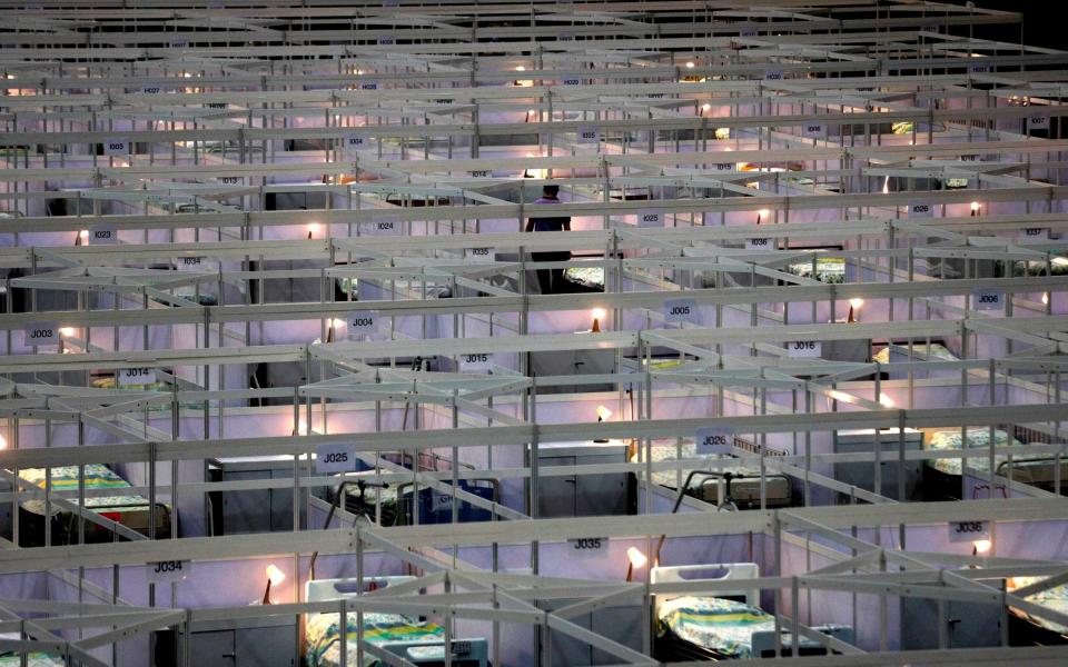 Rows of beds at the temporary field hospital  - AP Photo/Kin Cheung