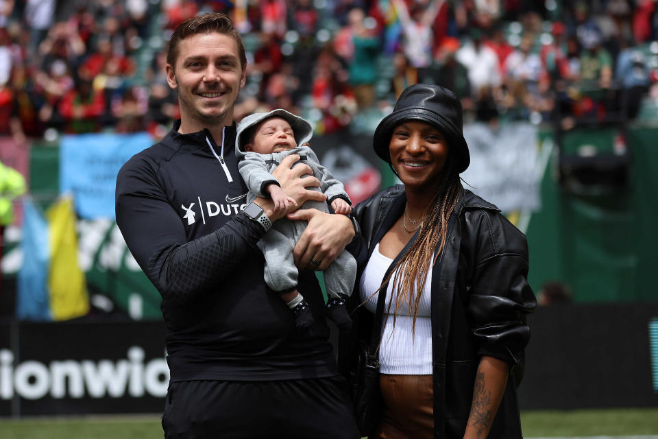 Portland Thorns FC defender Crystal Dunn with her husband, Pierre Soubrier, and their son, Marcel, at Providence Park in Portland, Oregon, on June 19, 2022. (Craig Mitchelldyer/USA TODAY Sports)