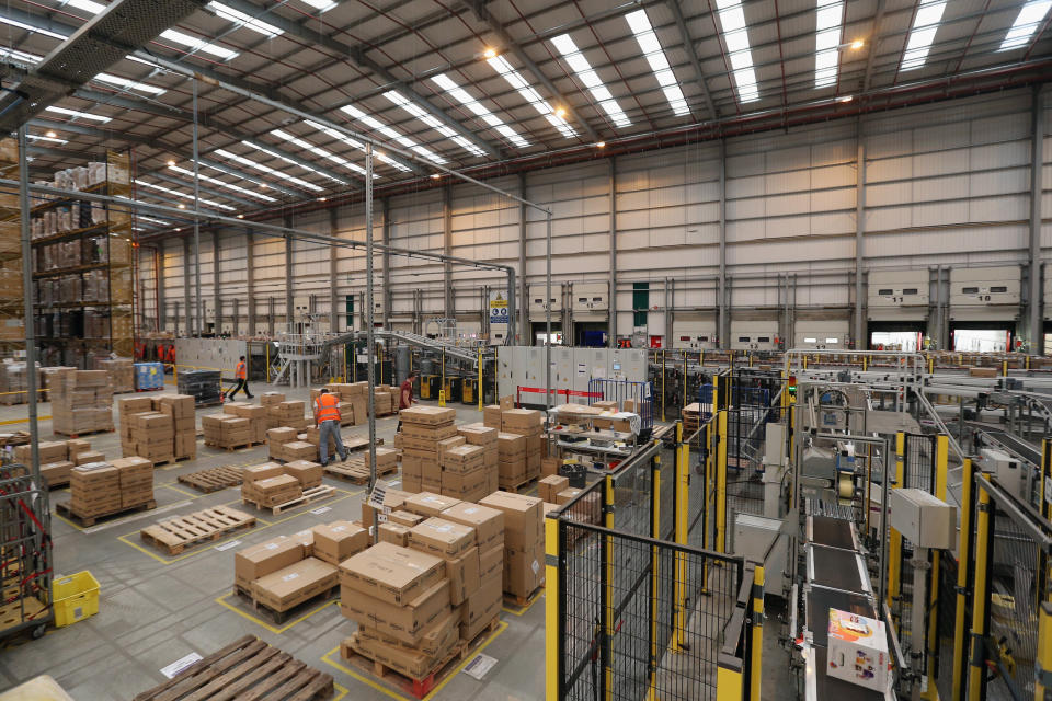 PETERBOROUGH, ENGLAND - NOVEMBER 28:  Employees select and dispatch items in the huge Amazon 'fulfilment centre' warehouse on November 28, 2013 in Peterborough, England. The online retailer is preparing for 'Cyber Monday', as it predicts the busiest day for online shopping in the UK will fall on Monday December 2nd this year. On Cyber Monday in 2012 amazon.co.uk recorded over 3.5 million individual items ordered, which equates to 41 items purchased per second. The Peterborough fulfilment centre is 500,000 sq ft, equivalent to approximately seven football pitches in floor area. Amazon are due to employ more than 1,000 seasonal staff to cope with increased demand in the run up to Christmas.  (Photo by Oli Scarff/Getty Images)