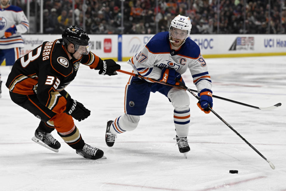 Edmonton Oilers center Connor McDavid (97) controls the puck against Anaheim Ducks right wing Jakob Silfverberg (33) during the second period of an NHL hockey game in Anaheim, Calif., Friday, Feb. 9, 2024. (AP Photo/Alex Gallardo)