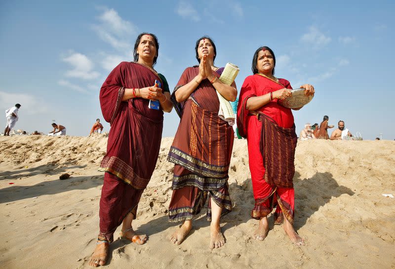 Women perform special prayers during the annular solar eclipse and for the victims of the 2004 tsunami on the 15th anniversary of the disaster, at Marina beach in Chennai