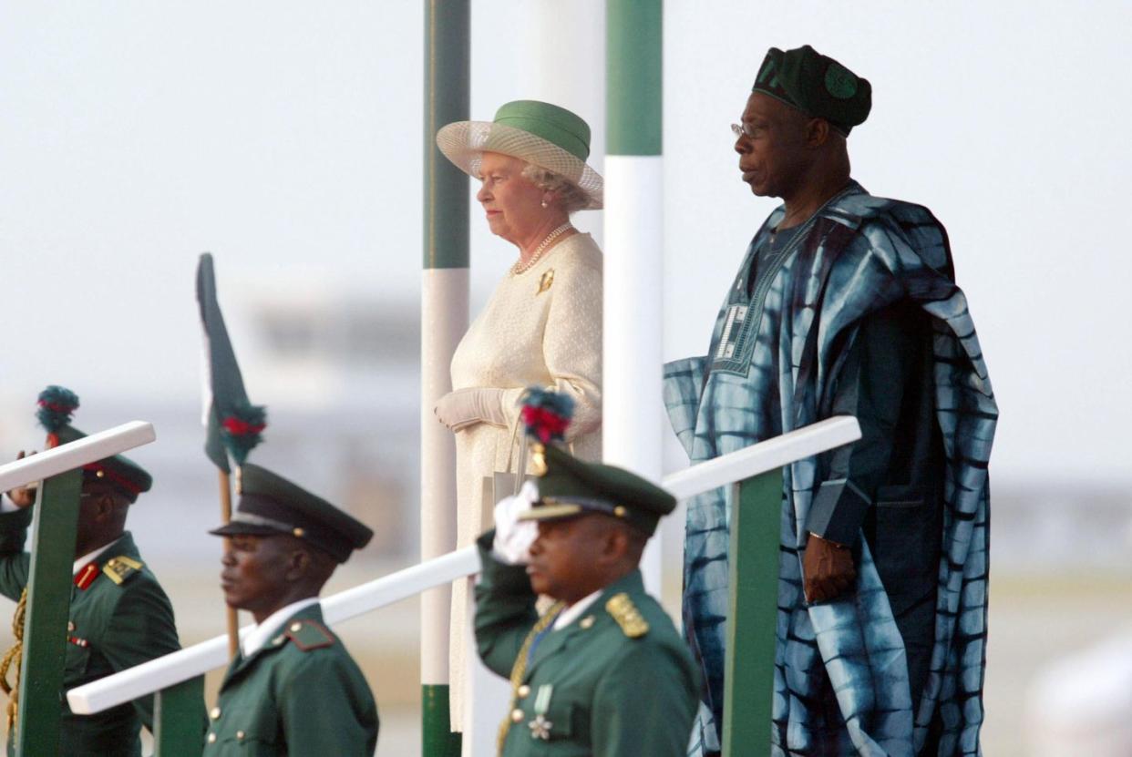 queen elizabeth ii of england stands nex