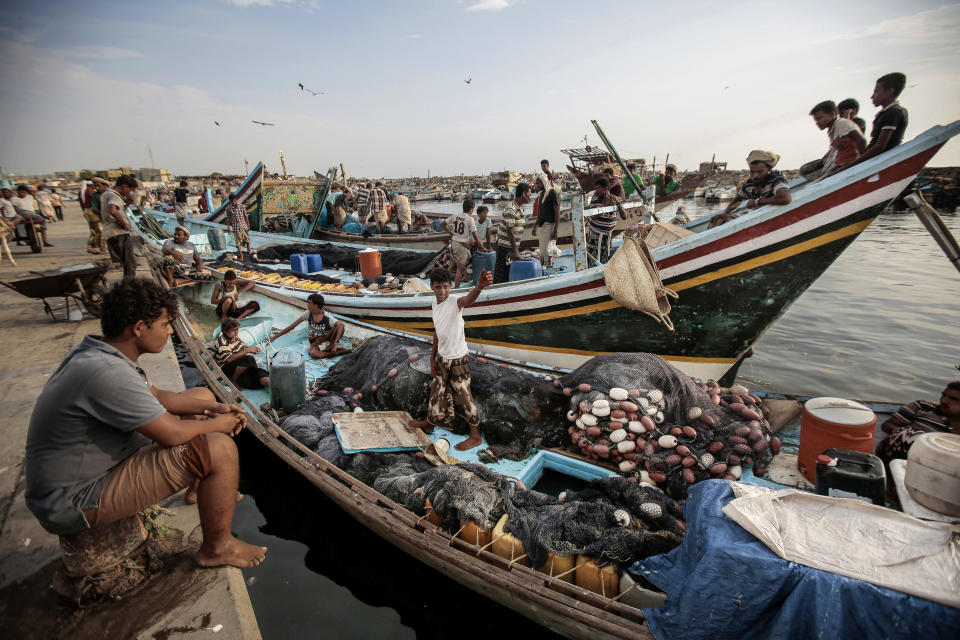 FILE - In this Sept. 29, 2018 file photo, fishermen rest on their boats before fishing at the main fishing port, in Hodeida, Yemen. Officials in Yemen said a cease-fire took effect at midnight Monday, Dec. 18, 2018, in the Red Sea port of Hodeida after intense fighting between government-allied forces and Shiite rebels erupted shortly before the U.N.-brokered truce. Yemen's civil war, in which a Saudi-led coalition is fighting on the government’s side against the rebels, has pushed much of the country to the brink of famine. (AP Photo/Hani Mohammed, File)