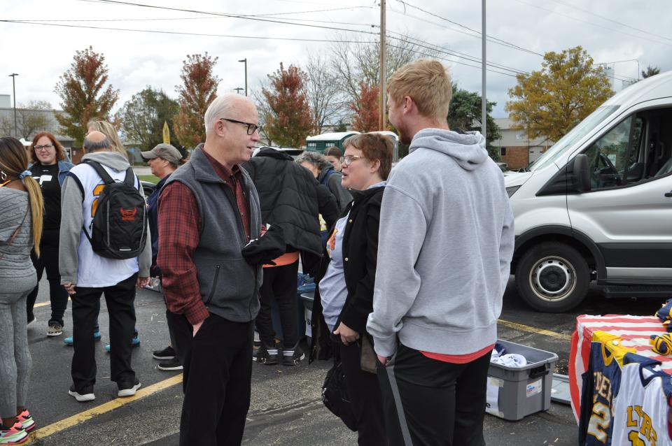 Jed Morison, left, talks to attendees, including Christine Brown, at a Central Ohio Special Olympics fall banquet in October. Morison is retiring after 23 years as the superintendent and CEO of the Franklin County Board of Developmental Disabilities.