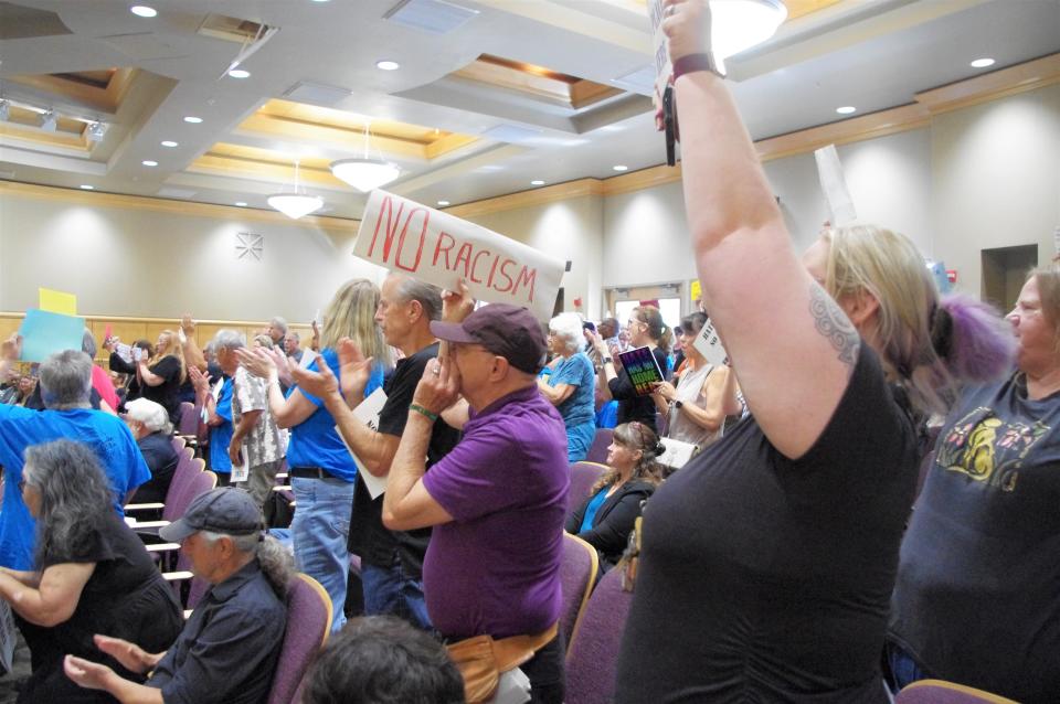 Members of the audience at a Shasta County Board of Supervisors cheer Tuesday June 6, 2023. The meeting drew about 100 people who protested against a Black man being kicked out of a recent supervisors meeting for complaining about a white man using a racist slur.